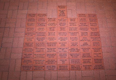 A brick floor with many small black textDescription automatically generated with medium confidence
